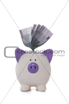 Euros sticking out of hand painted purple and white piggy bank