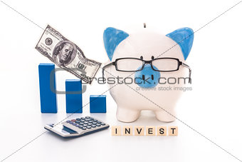 Blue and white piggy bank wearing glasses with invest message