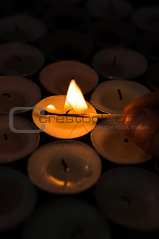 Hand lighting candle with match
