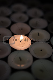 Single candle lighting in the dark