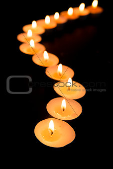 Candles lighting in a curved line