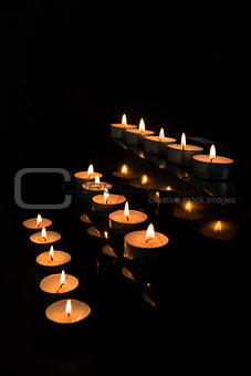 Candles at the alter lighting up the darkness