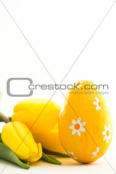 Yellow easter egg with yellow tulips