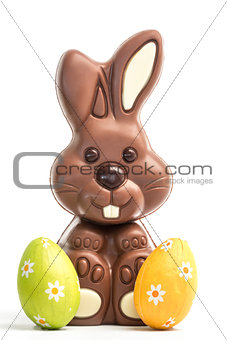 Cute chocolate bunny with two easter eggs