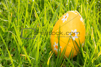 Orange easter egg in the grass