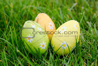 Three easter eggs in the grass