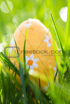 Easter egg wrapped in foil nestled in the grass