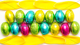 Colourful foil wrapped easter eggs with tulip petals