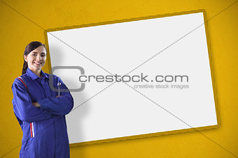 Female mechanic standing in front of a blank screen