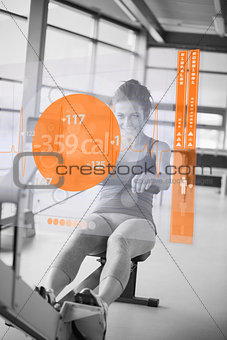 Front view of a girl on rowing machine with futuristic interface