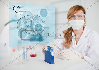 Chemist working in protective suit with futuristic interface showing a brain
