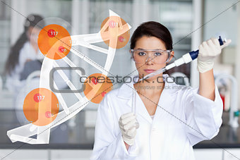 Pretty lab worker adding chemical to test tube