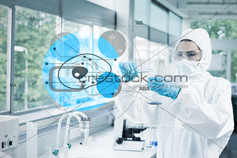 Scientist in protective suit working with cell diagram interface