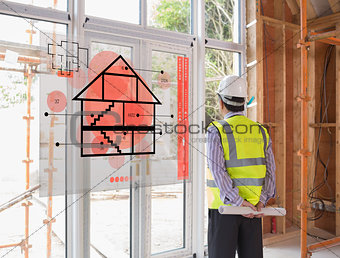 Architect looking out window with red hologram interface in foreground