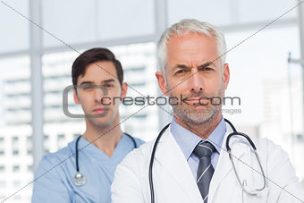 Two serious doctors standing