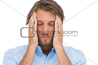 Man touching his temples to calm a headache