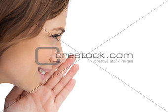 Close up of a brunette woman whispering a secret