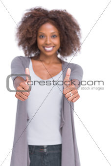 Cheerful woman giving thumbs up