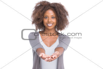Smiling brunette holding her hands out