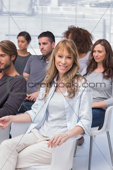 Woman smiling at camera in group therapy
