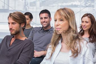 Patients listening in group therapy with one man smiling