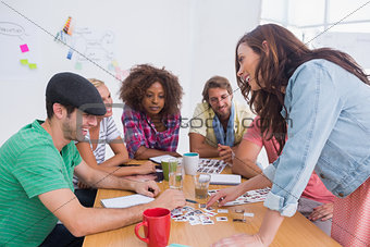Editor picking photographs in a meeting