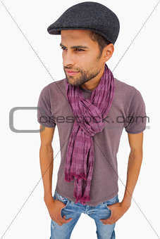 Thougthful man wearing peaked cap and scarf