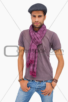 Serious man wearing peaked cap and scarf