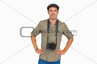 Happy man in peaked cap with camera around his neck