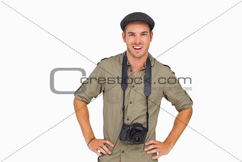 Smiling man in peaked cap with camera around his neck