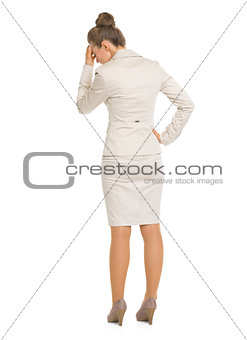 Full length portrait of frustrated business woman . rear view