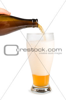 Hand holding bottle of beer and beer mug