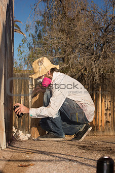 Crouching Man Spray Painting