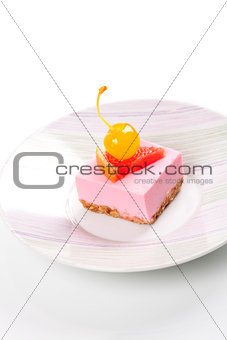Pink cheesecake with maraschino cherry and grapefruit slice