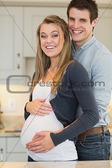 Man embracing pregnant partner