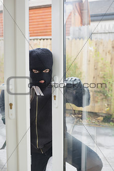 Burglar opening carefully the door