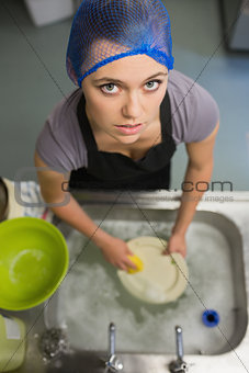 Woman looking up from doing the washing up