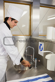 Concentrated chef washing hands