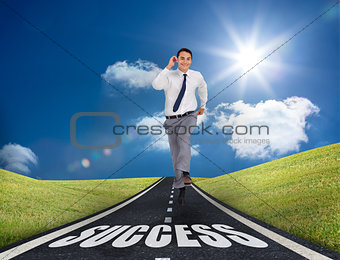 Happy businessman running on a road