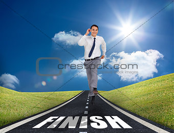 Smiling businessman running on a road