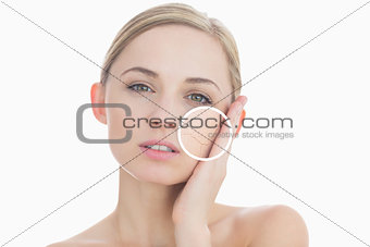 Pure woman touching her skin with close up of her wrinkles