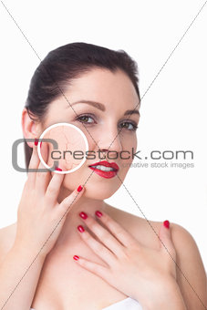 Attractive woman rubbing her skin with close up of her wrinkles