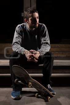 Skater sitting on steps in the skate park