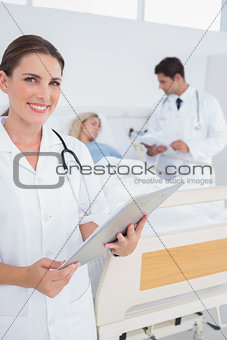 Smiling doctor holding folder