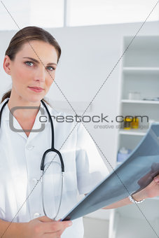 Smiling woman doctor holing a x-ray