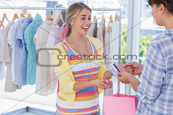 Cashier giving credit card to customer