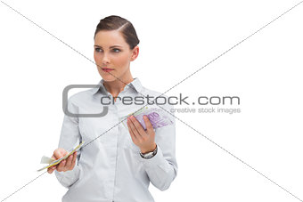 Businesswoman holding wads of cash