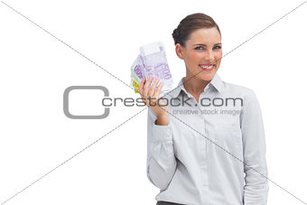 Happy businesswoman showing lots of money