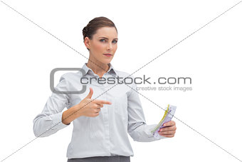 Businesswoman pointing to money in her hand
