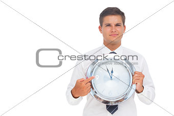 Businessman holding a clock